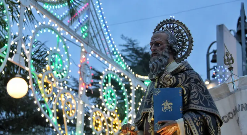 The statue of Saint Anthony the Abbot in front of the lit arches of the January feast